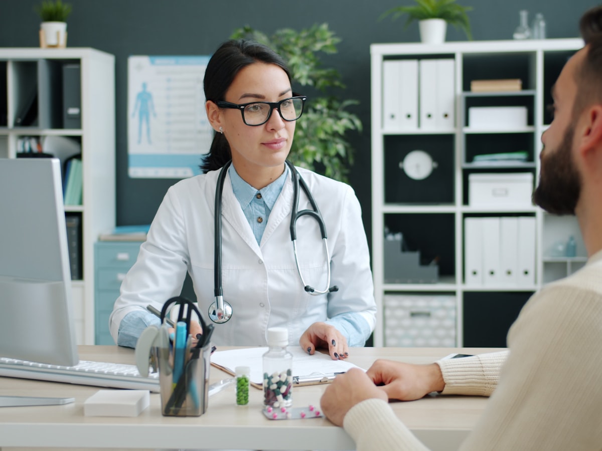 Doctor consulting with a patient at a computer